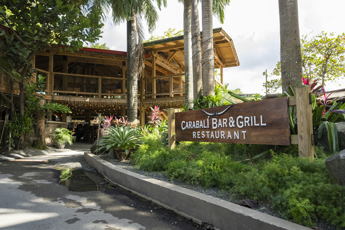 Outdoor view of Carabali Bar & Grill with tropical plants.