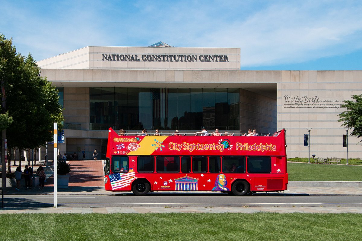 Red double-decker bus in front of the National Constitution Center.